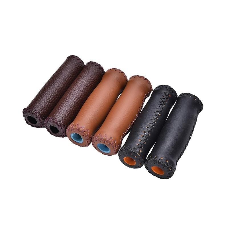Close up of vintage-style artificial leather bicycle handlebar grips with aluminum alloy rings.