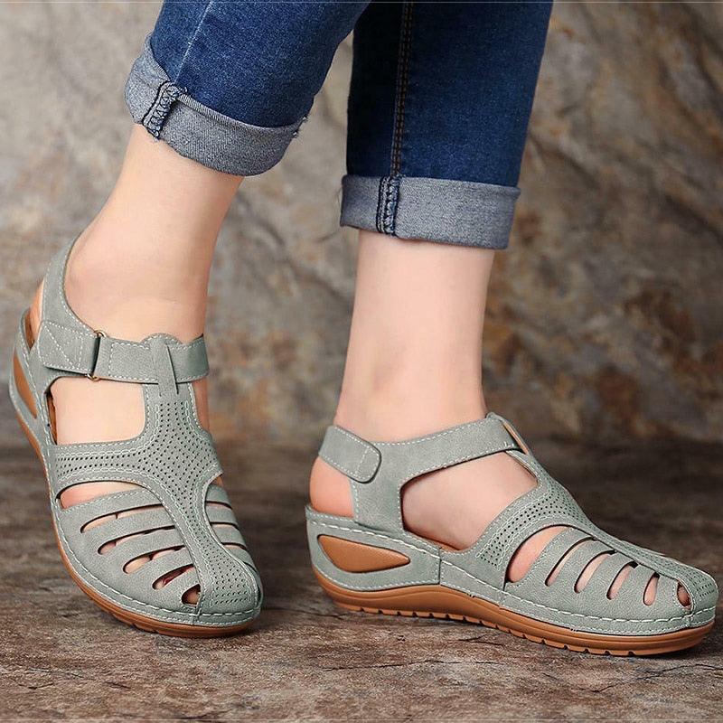 Women wearing classic grey vintage closed toe platform walking sandals on a summer day