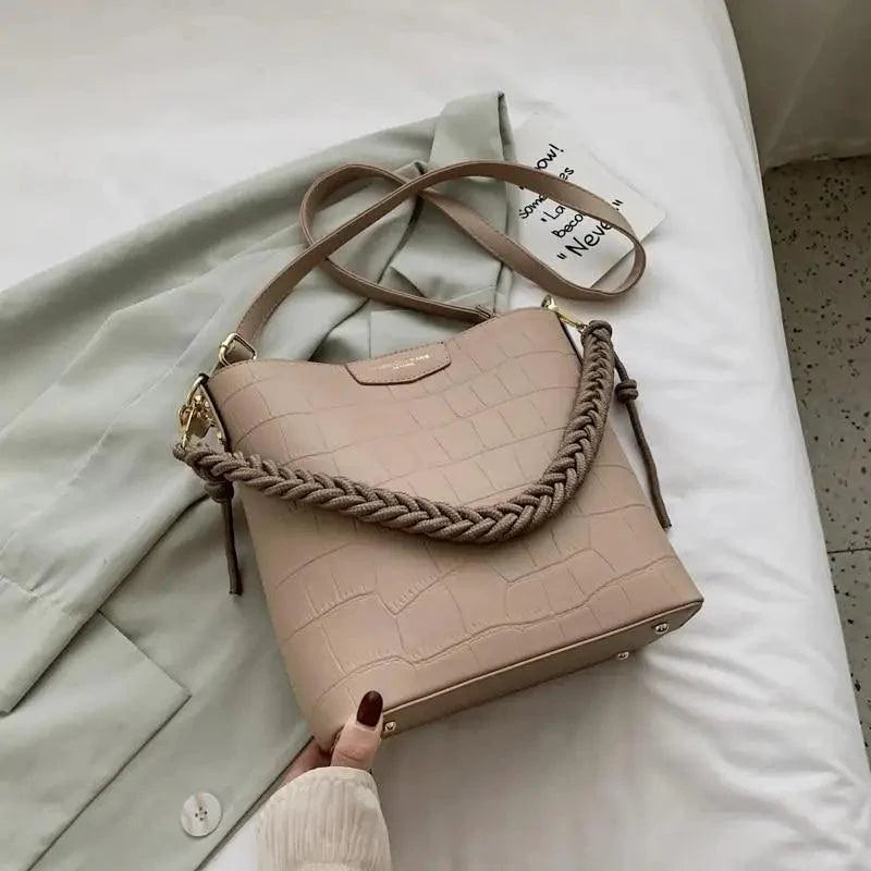 Vintage style women's bucket bag featuring a stone pattern design in a shoulder bag silhouette.