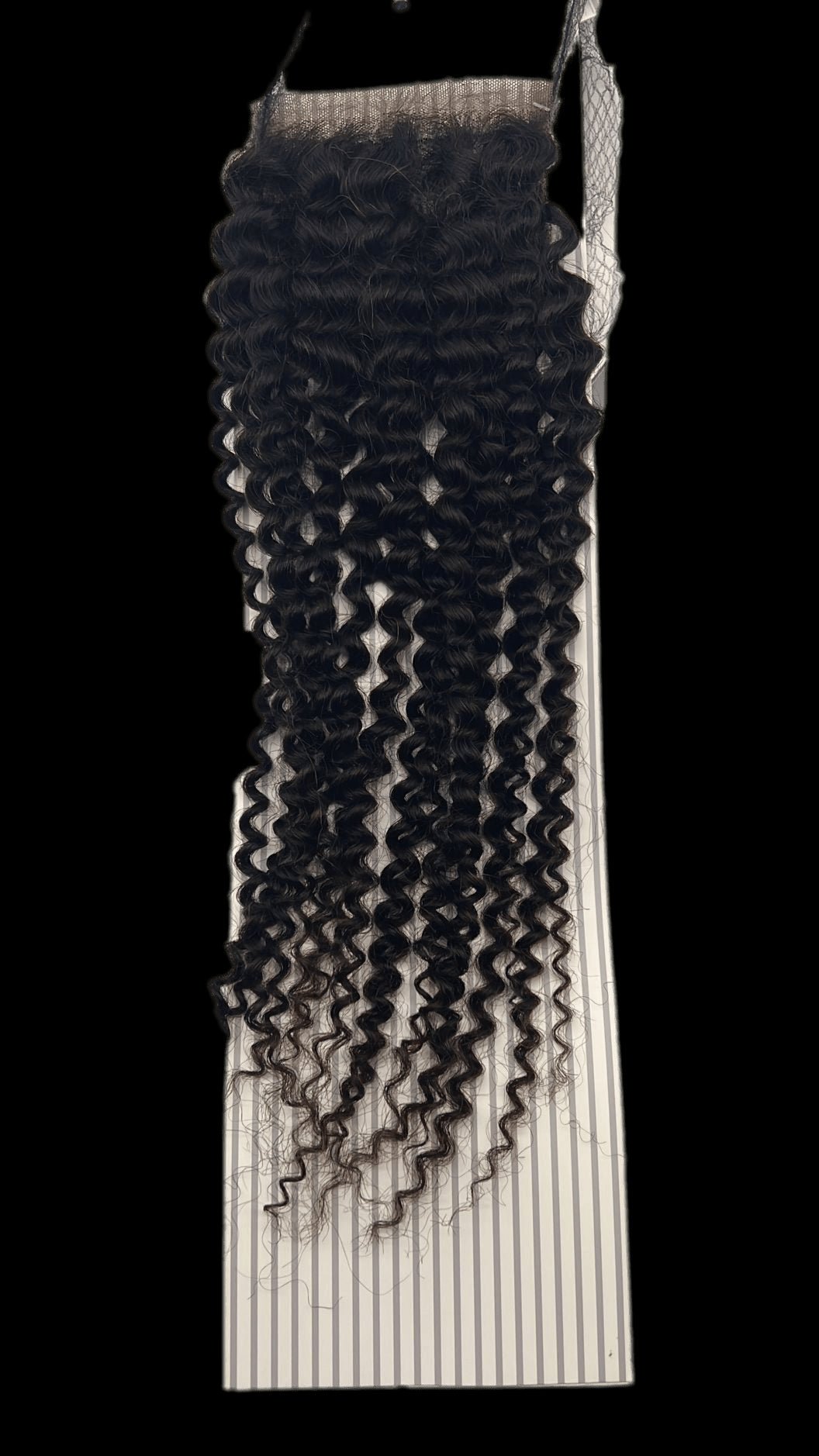 Close up of 4x4 bohemian virgin hair closure in natural black with a soft, natural texture.