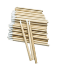 A bag of 50 professional eyelash spoolie brushes with sustainable bamboo handles for lash extension application.