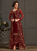 Maroon heavy net Pakistani suit featuring intricate embroidery and an A-line silhouette.