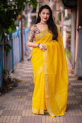 Mustard linen saree with self-weaving checks and golden pattu border.