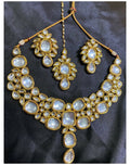 Traditional Golden Kundan work necklace set with intricate stone design.