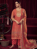Women wearing an orange organza jacquard straight kurta with matching muslin trousers and dupatta