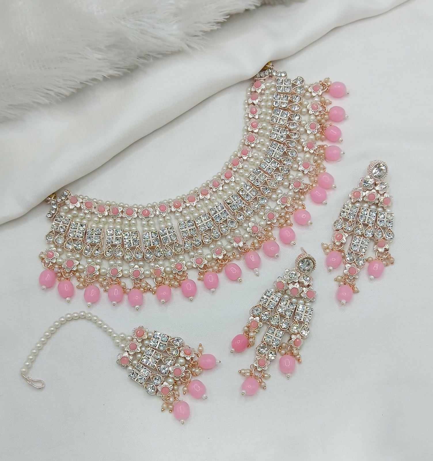 Pink stone and pearl work necklace set with matching earrings and tikka