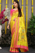 Yellow Banarasi silk saree with zari woven borders and a contrasting pink blouse.
