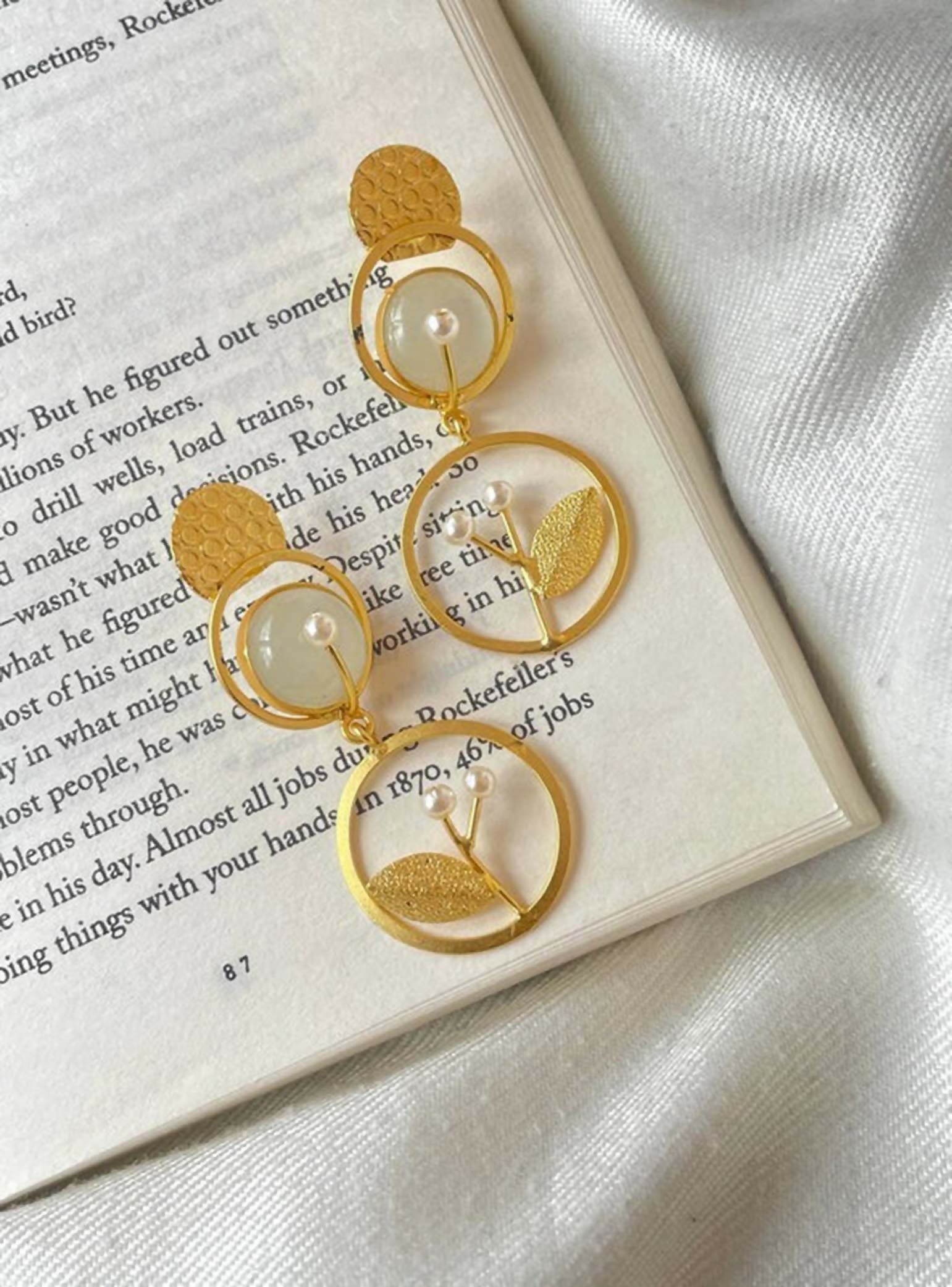 Golden leaf and pearl drop earrings with Monalisa stone detailing