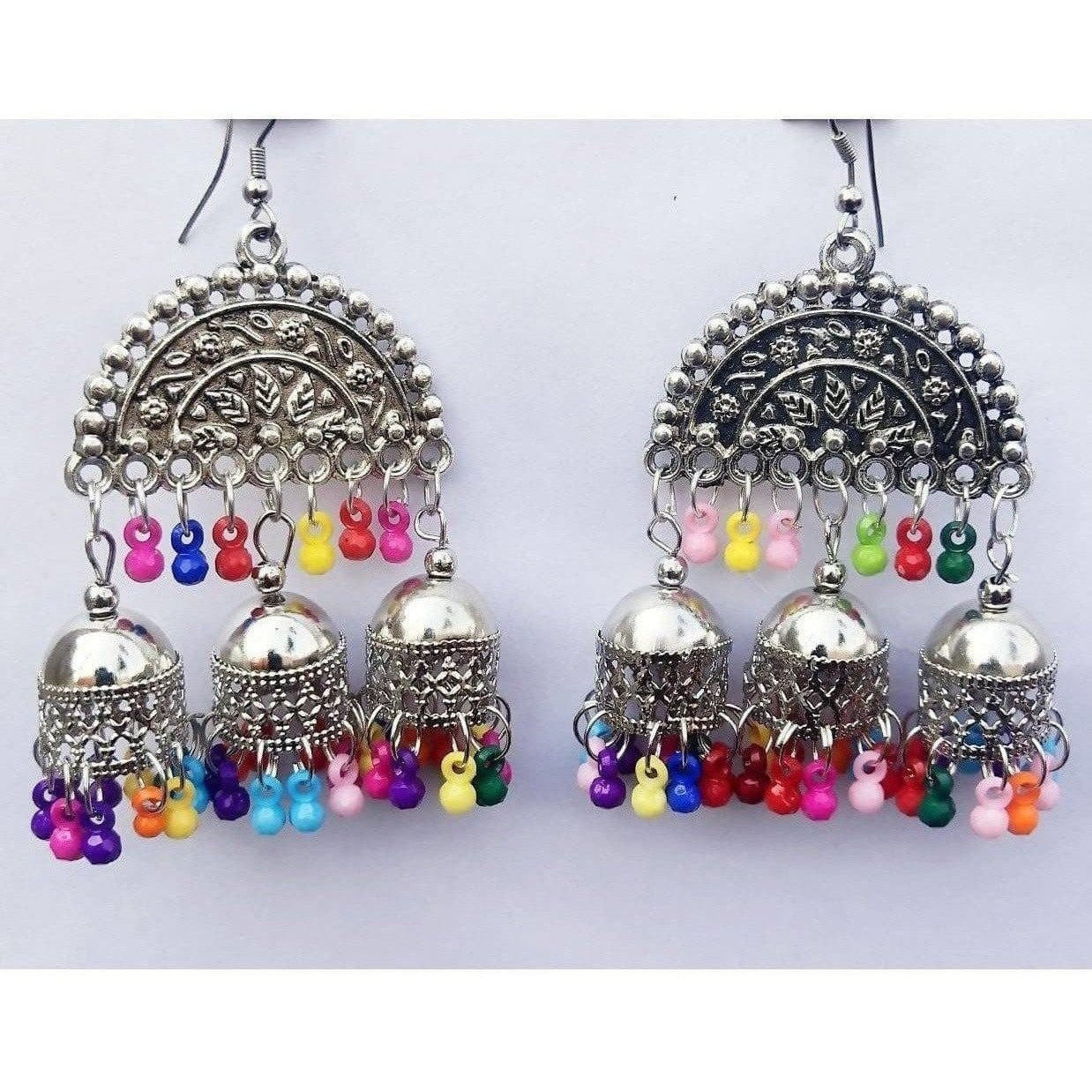 Half moon design triple jhumka earrings with multi-color pearls and silver oxidized metal.
