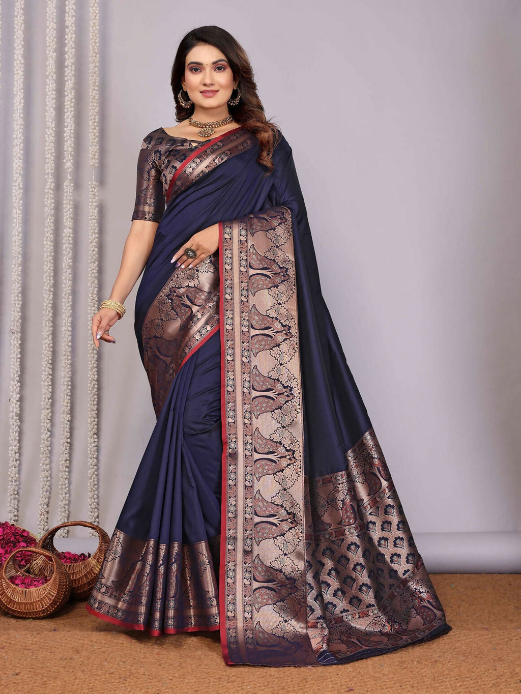 A navy blue woven Banarasi silk saree with intricate detailing, paired with an unstitched blouse.