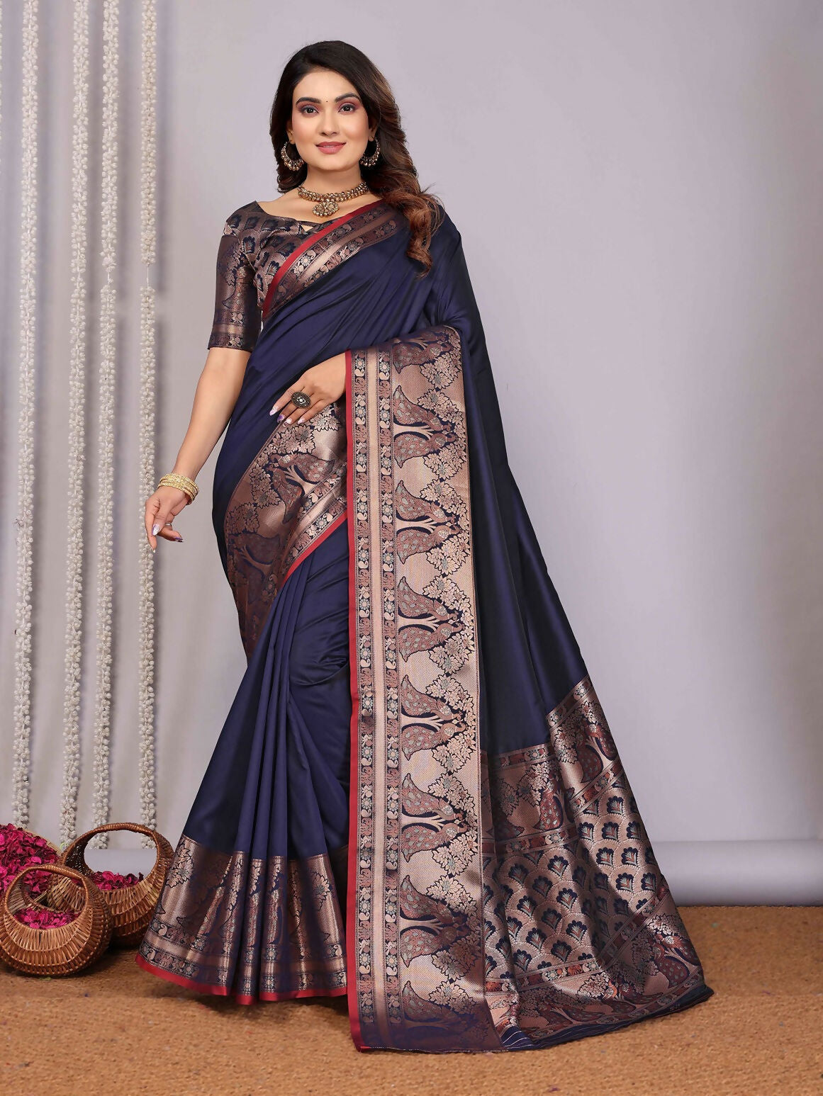 A navy blue woven Banarasi silk saree with intricate detailing, paired with an unstitched blouse.