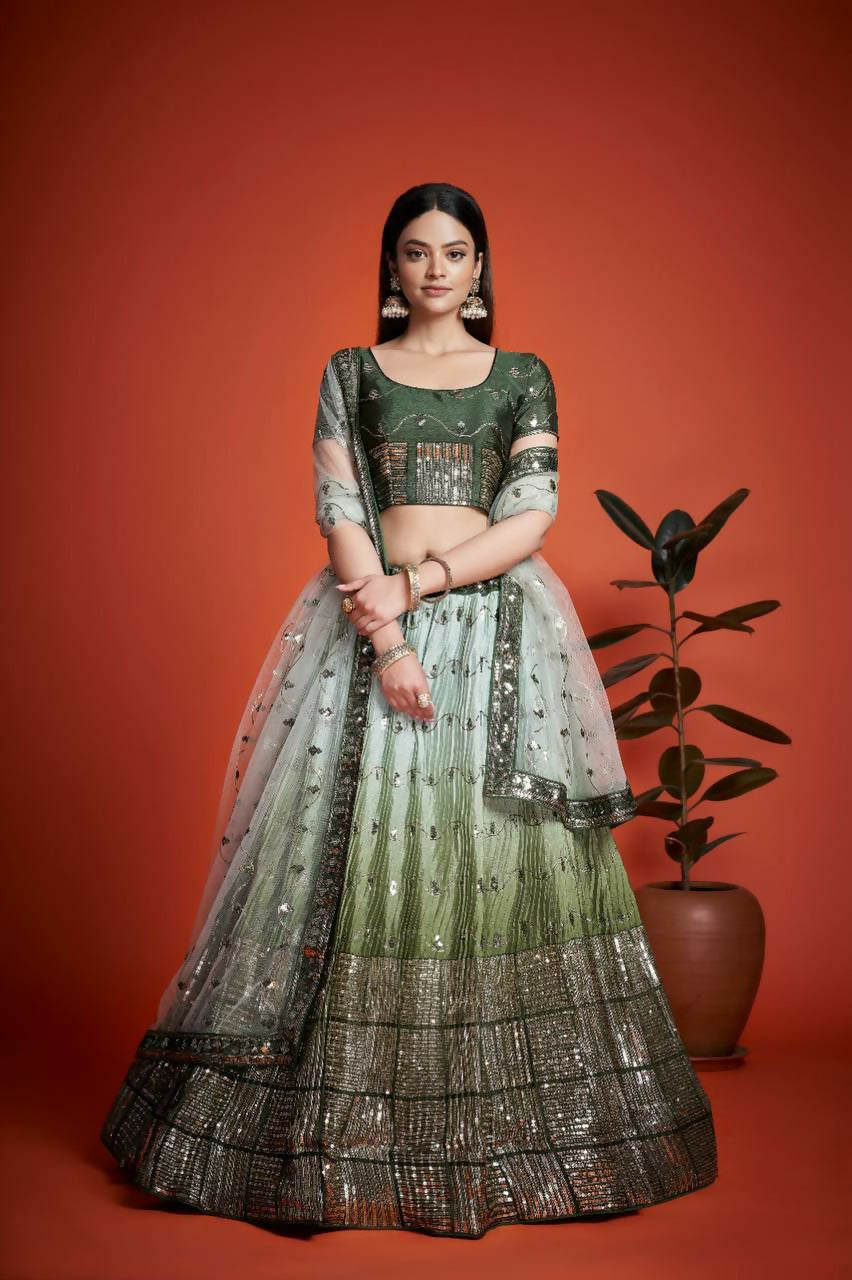 Women wearing a glamorous mehendi green heavy chinon lehenga choli with intricate sequins embroidery.