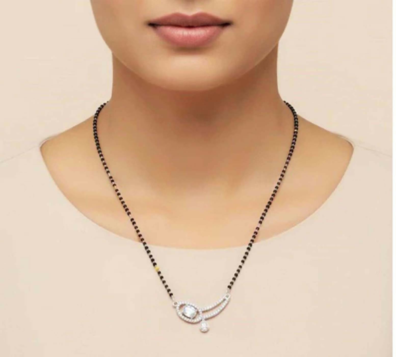 Elegant white moonstone mangalsutra made of brass, suitable for traditional and festive wear.
