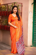 Orange silk blend Ajrak saree with traditional bhandi prints and unstitched blouse