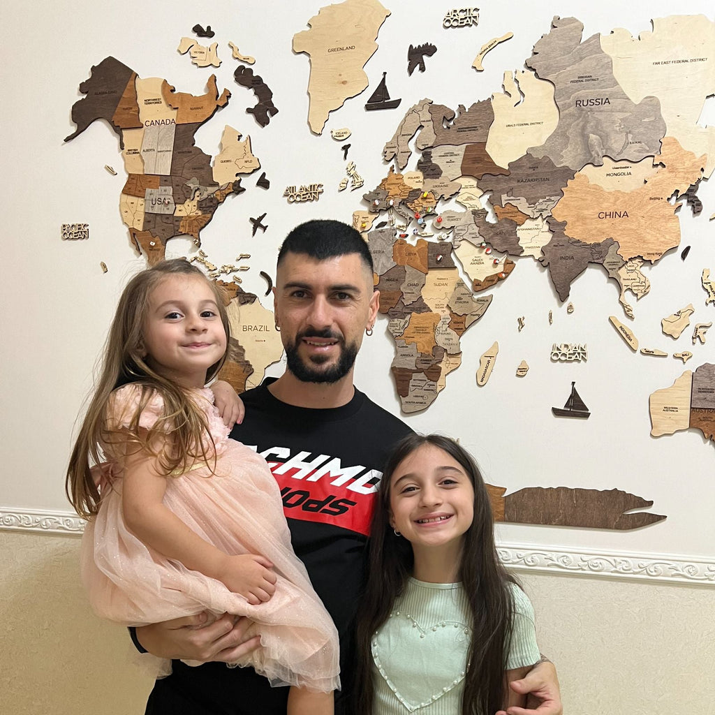 Decorative 3D wooden world map wall art for kitchen interior featuring engraved details and country borders.