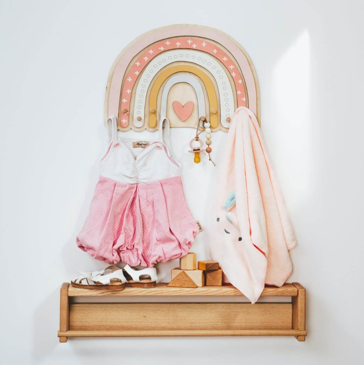 Colorful rainbow wall hanger with heart-shaped hooks for kids' room decor