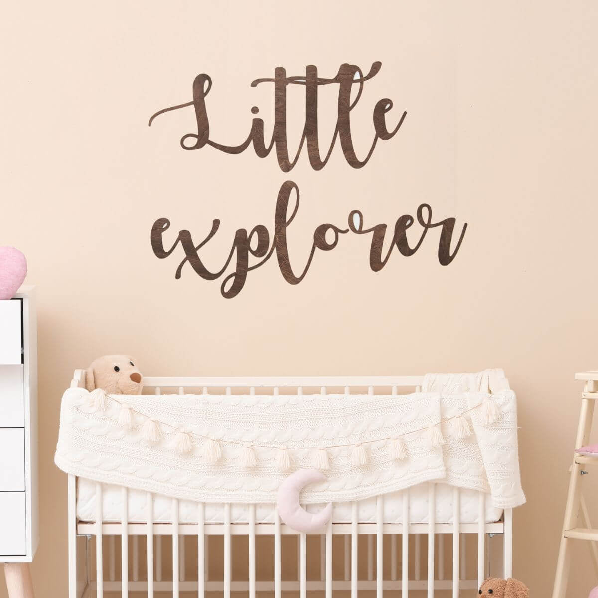 Close-up of stylish wooden baby nursery wall quote sign on a neutral nursery wall
