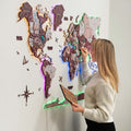 3D Luminous LED Wooden World Map 2.0 in Cappuccino wood tones featuring glowing ambient neon lighting on a modern living room wall.