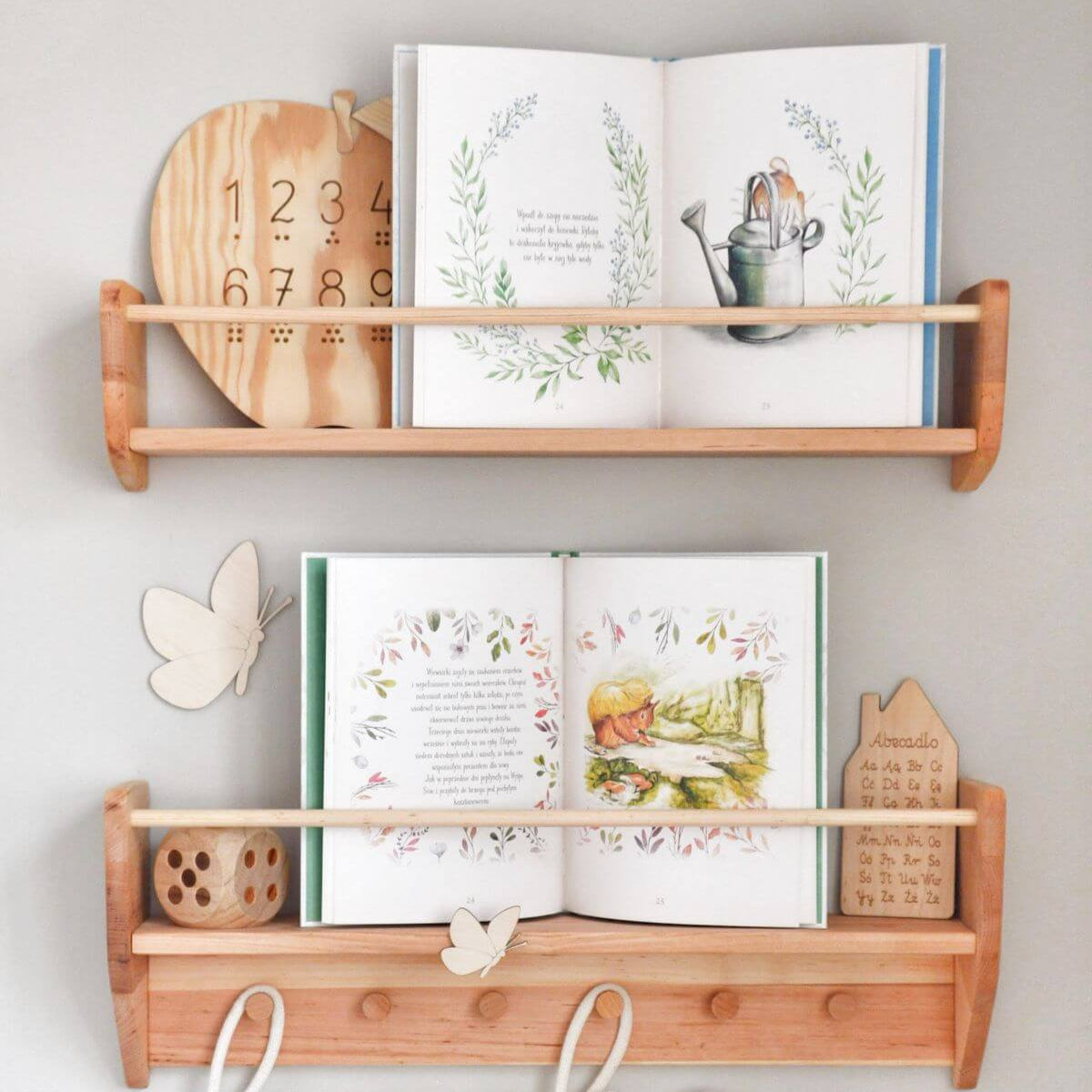 Wall-mounted nursery bookshelf displaying children's books in an organized, tidy room