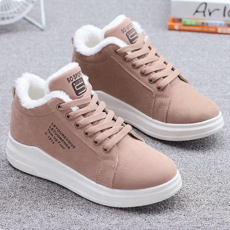 Women's fur-lined winter snow boots in white with lace-up sneaker design.