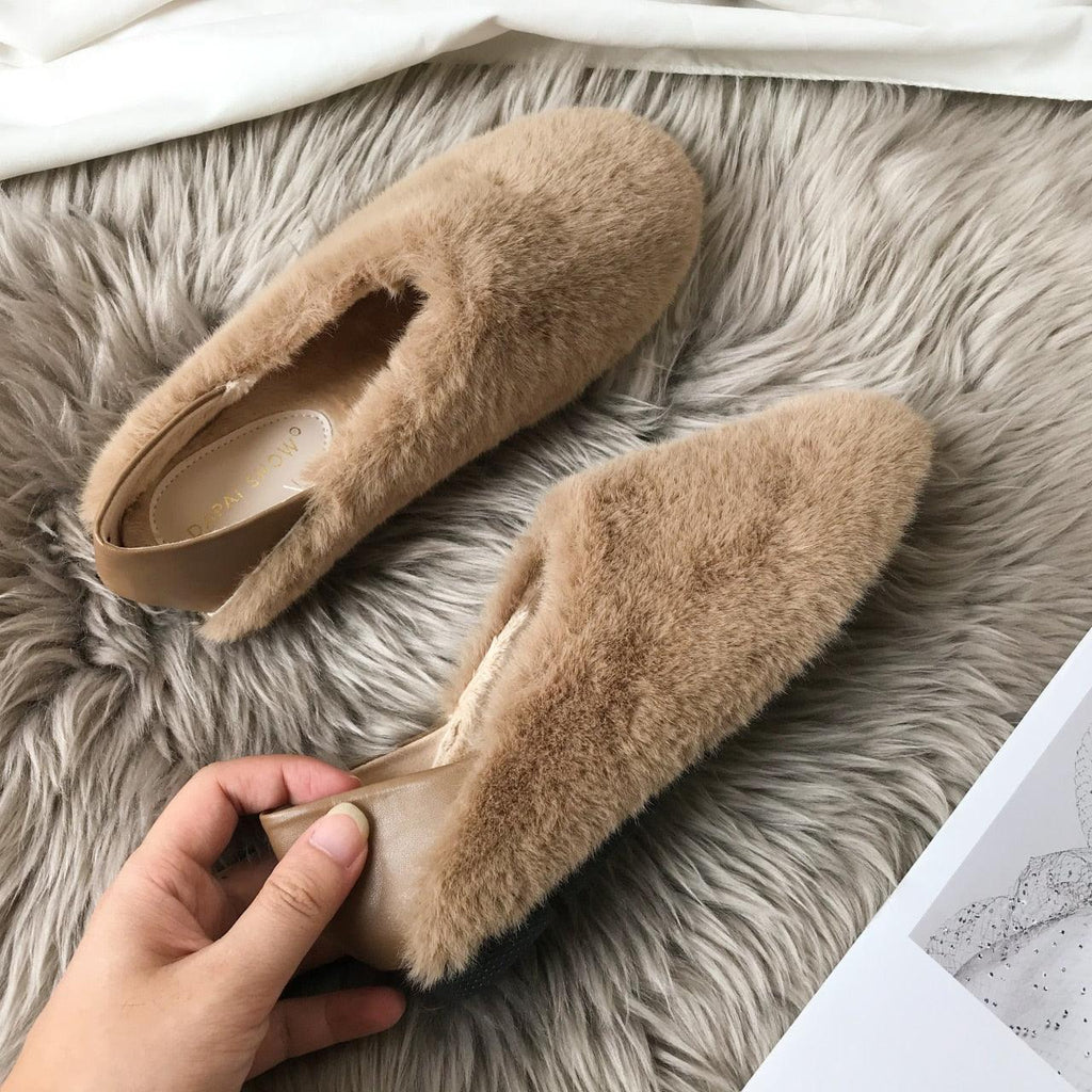 Women's fluffy fur loafers with cable knit upper and anti-skid sole in a house setting