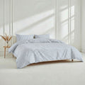 A bed set featuring soft long-staple cotton sateen fabric in a bedroom setting.