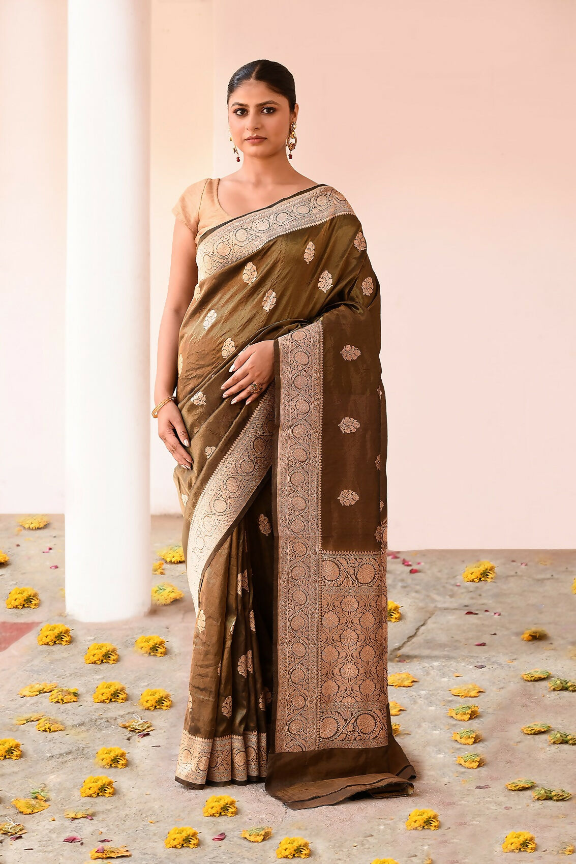 Olive green pure Katan handloom Banarasi silk saree showing detailed textile work.