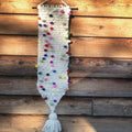 A decorative Whimsical Winter Wall Hanging created from an easy beginner knitting pattern.