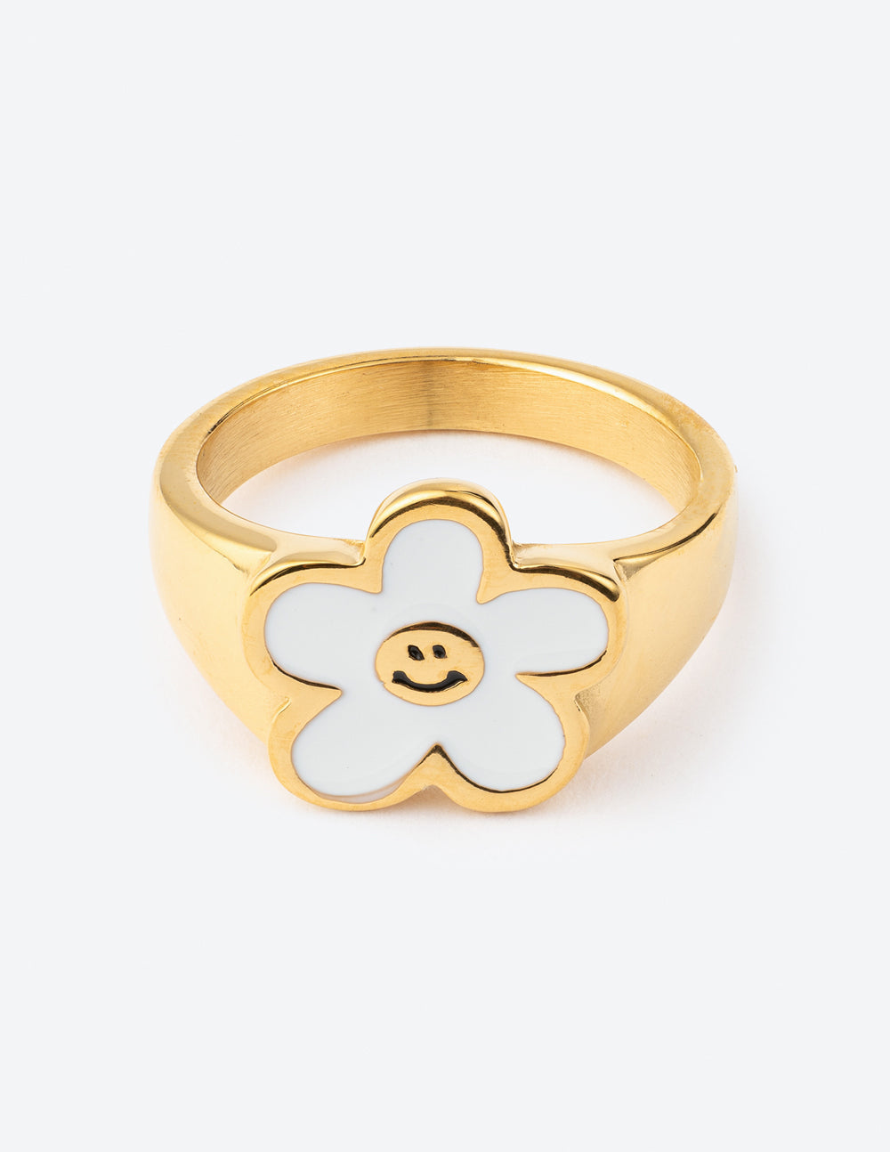 White smiley flower ring on a neutral background