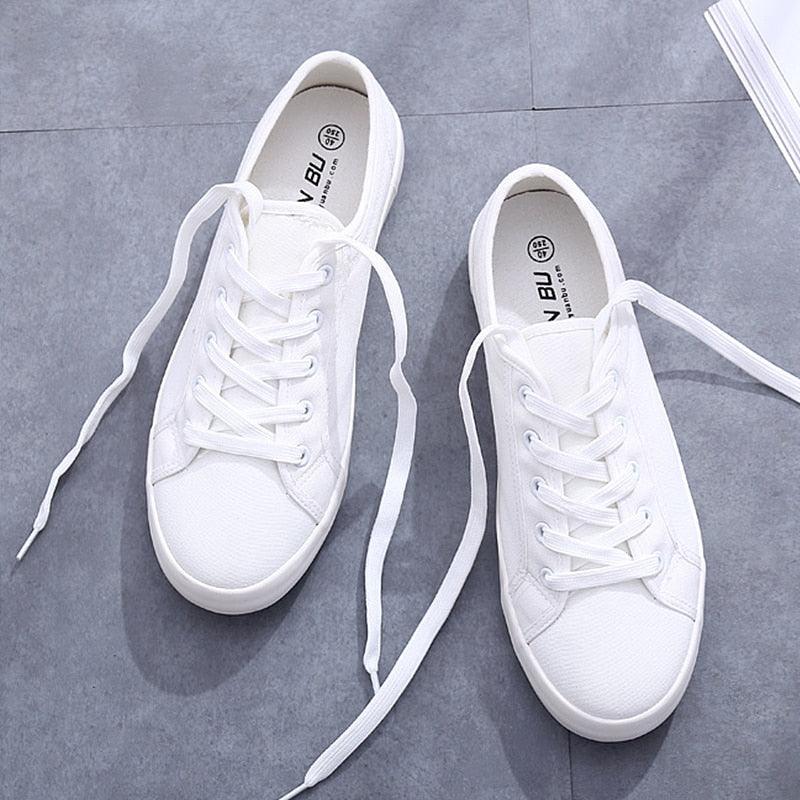 Women's white casual canvas slip-on sneakers with a comfortable flat sole.