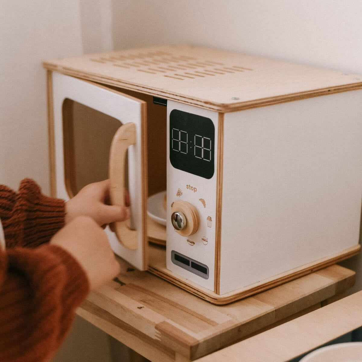 Minimalist Scandinavian wooden microwave toy in white and light-wood finish