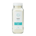 Bottle of Wholesum Bath Milk featuring organic coconut, buttermilk, and goat milk