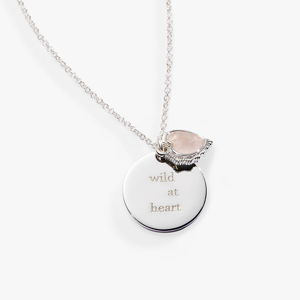 Silver-tone Wild at Heart necklace with engraved charm and heart-shaped pink crystal.