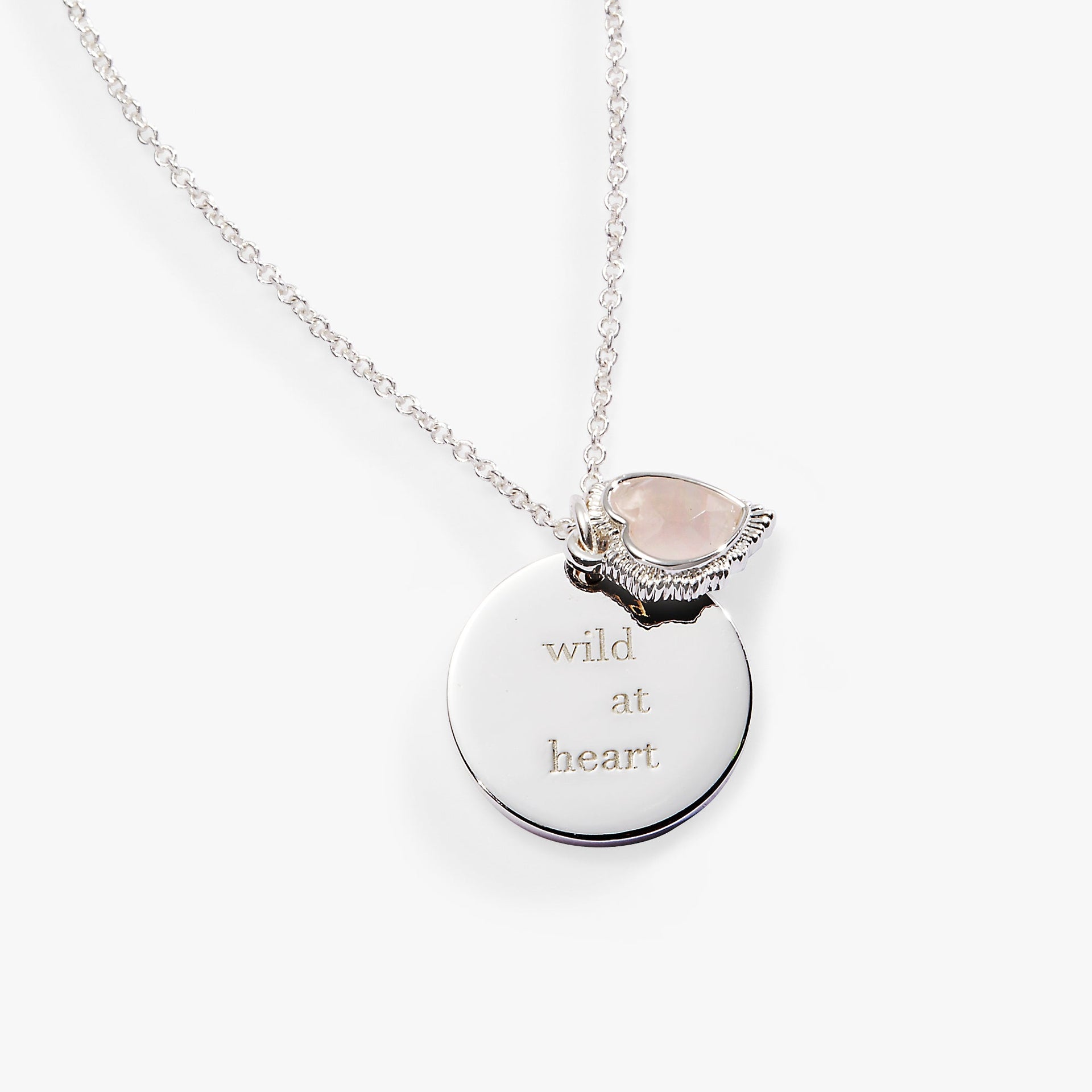 Silver-tone Wild at Heart necklace with engraved charm and heart-shaped pink crystal.