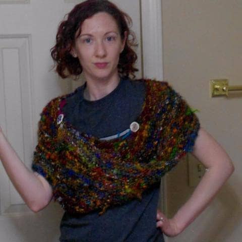 Finished Wild Peacock Wrap featuring vibrant fibers and button details