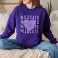 A person wearing a purple sweatshirt with a Wildcats leopard heart graphic design; a flat-lay view of the same design on a purple T-shirt.
