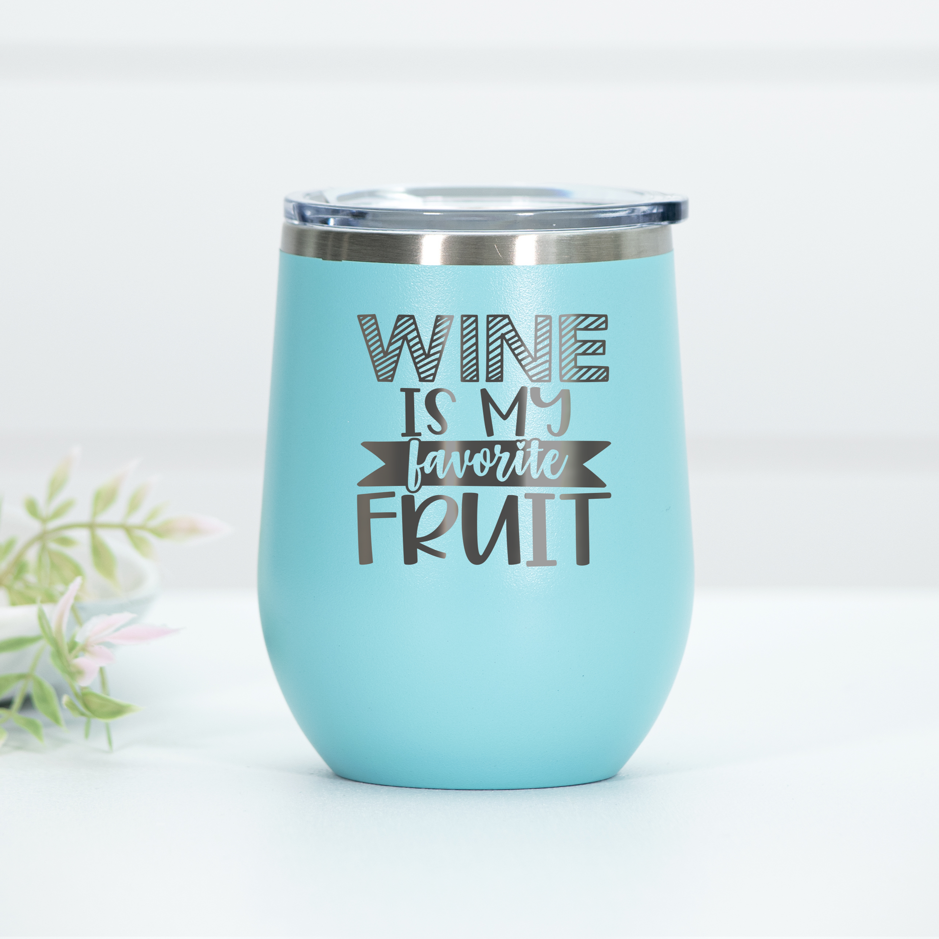 Teal stemless wine tumbler with Wine Is My Favorite Fruit text laser engraved on the front