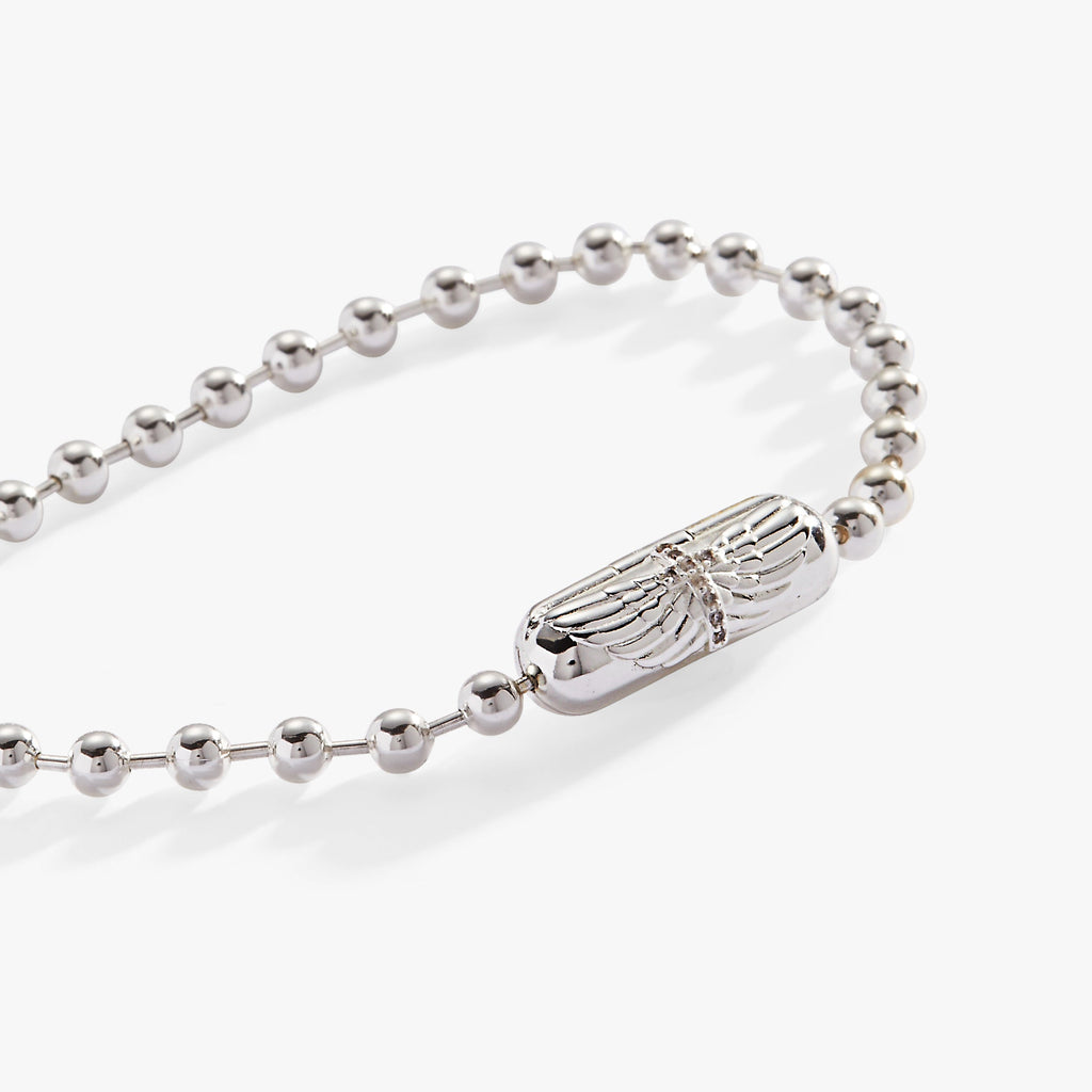 Silver ball chain bracelet featuring a barrel clasp with an engraved cross and angel wings.