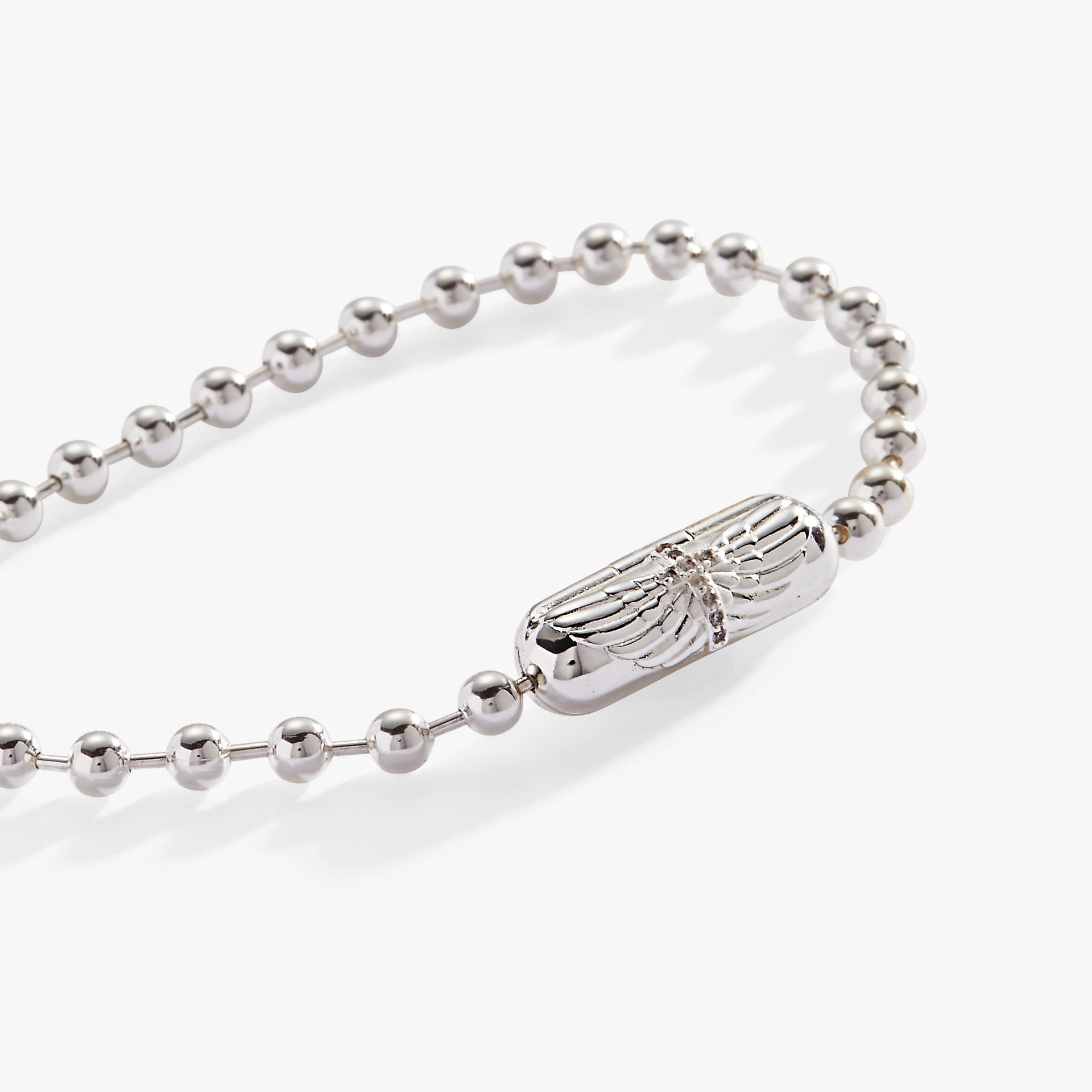 Silver ball chain bracelet featuring a barrel clasp with an engraved cross and angel wings.