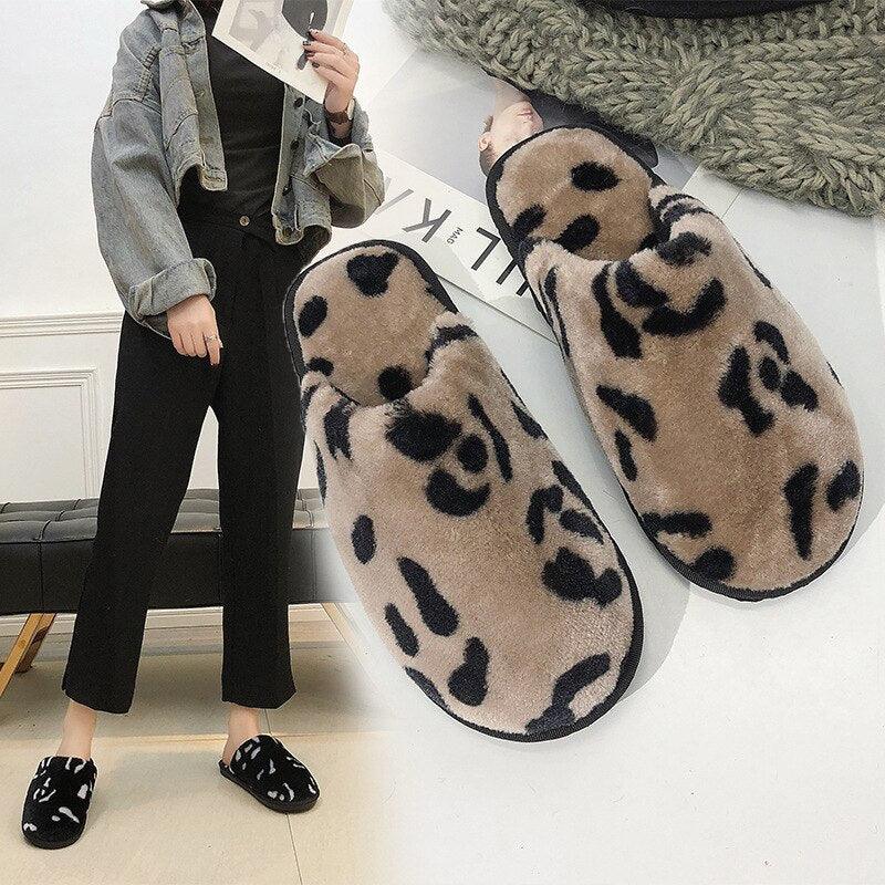 Women wearing cozy, brown and black leopard print fuzzy memory foam house slippers