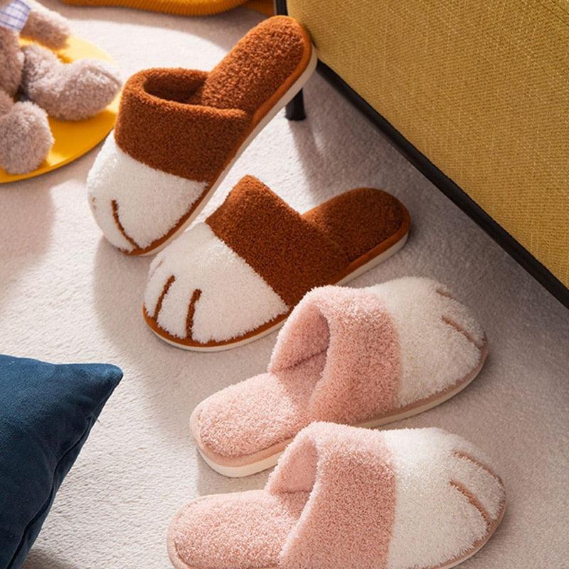 Close up of cute cat paw themed fuzzy brown and white indoor slippers for women