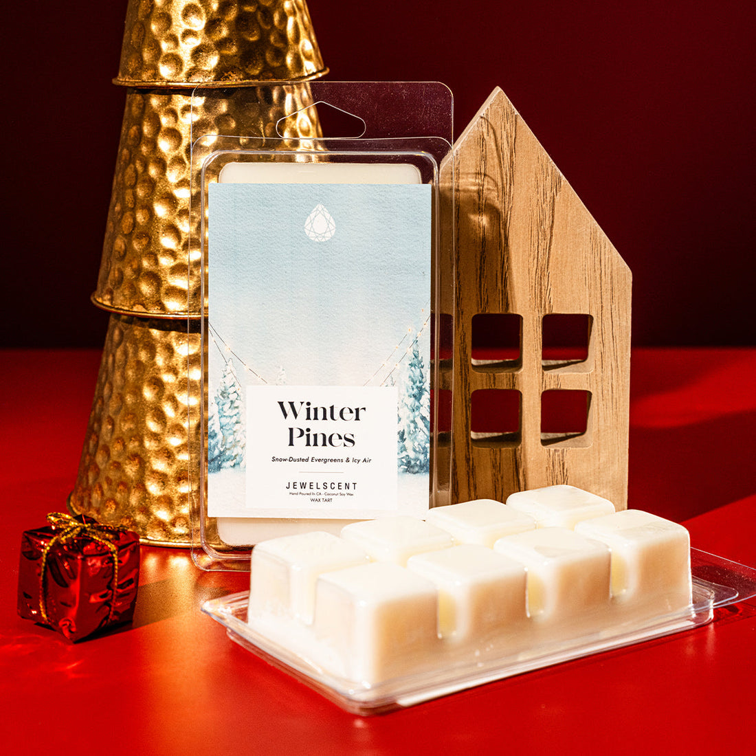 Winter Pines scented wax tart packaging in front of holiday decorations