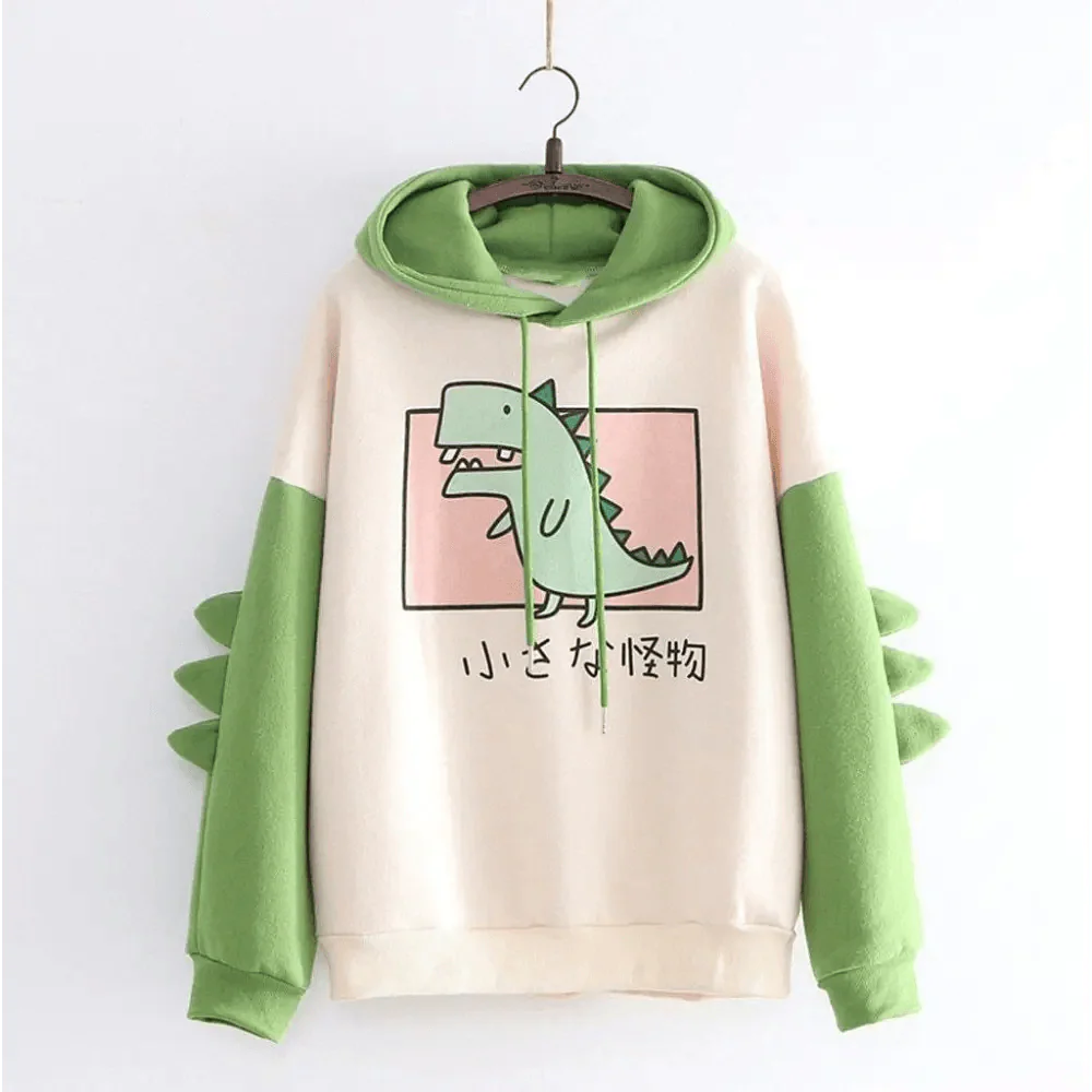 Toddler wearing a cute long sleeve hoodie with dinosaur print, featuring a soft cotton-blend fabric.