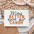 Rustic wooden Halloween sign with white background and text reading Witch Better Have My Candy in black and orange lettering