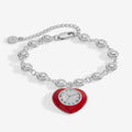 Wizard of Oz Tin Man linear bracelet featuring a red heart charm with a clock, in silver and gold tones.