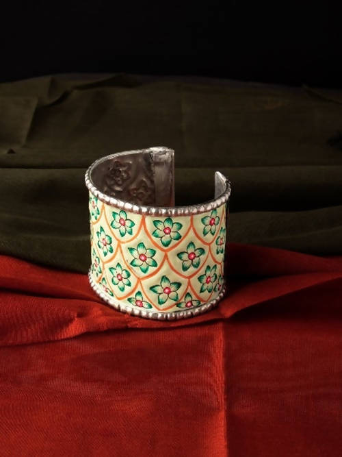 A beautiful hand-painted silver-plated brass kada bracelet with intricate oxidised detailing.