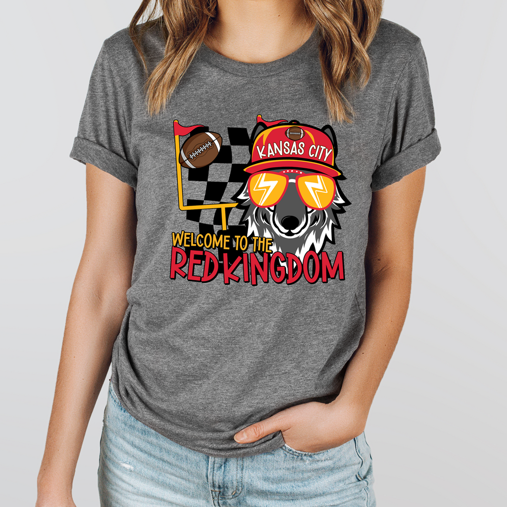 A grey graphic tee and sweatshirt featuring a cartoon wolf wearing a Red Kingdom football cap and sunglasses with the text Welcome to the Red Kingdom.