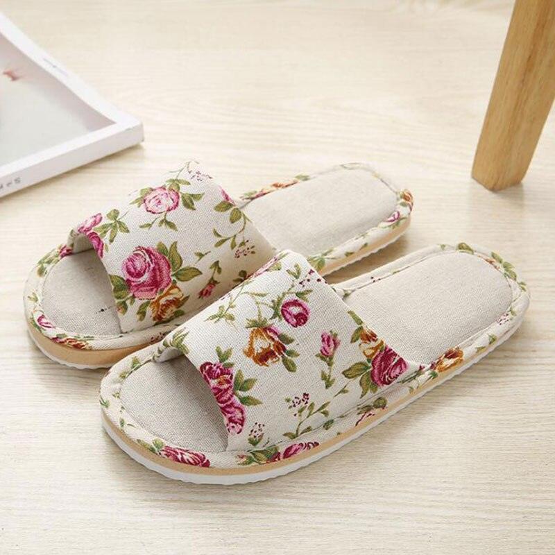 Women's floral linen slippers with sage green and rose pink botanical print on a beige background