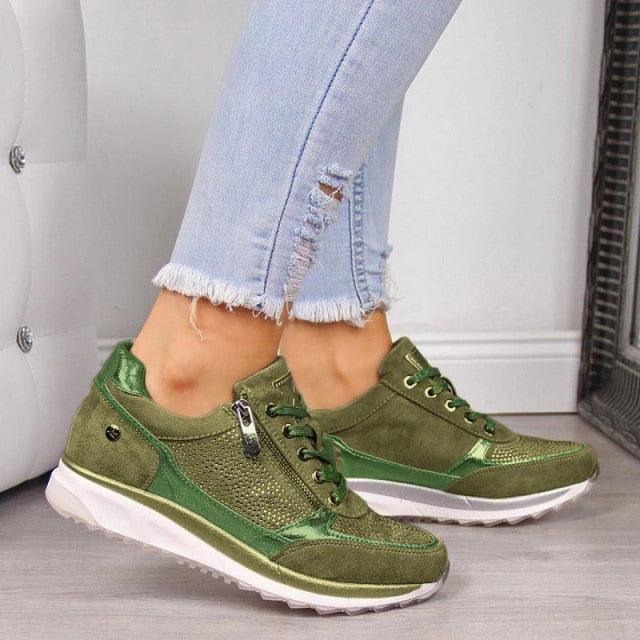Women's high-top platform sneakers in muted tones featuring lace-up and zipper closure.