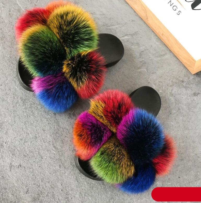 Women's glamorous multi-colored faux fur slides with black non-slip soles viewed from the side